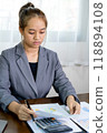 Businesswomen bookkeeper hand use calculator analysis the graph for Setting challenging business goals and ready to achieve target at home office 118894108