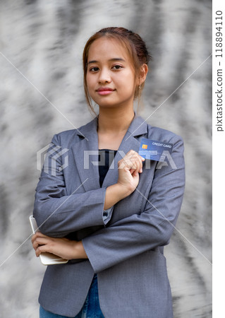 Businesswoman holding mock-up credit card for online shopping on smartphones, payment E-commerce, internet finance bank, spend money electronic wallet 118894110