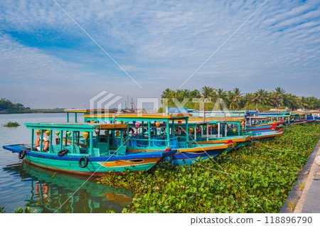 Traditional wooden Vietnamese boats on Thu bon river in the old town in Hoi An in Vietnam in summer 118896790
