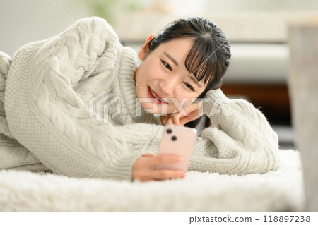 Portrait of a woman operating a smartphone Portrait of a woman operating a smartphone 118897238