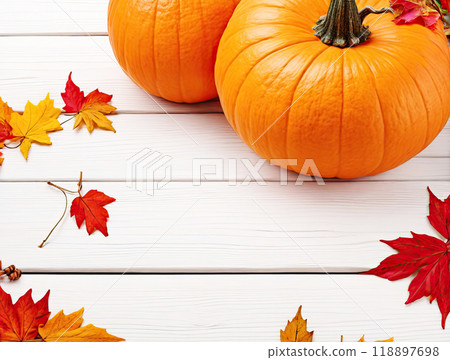 pumpkins and leaves on a white wooden background 118897698