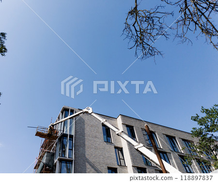 workers on a hanging cradle carrying out repair work 118897837