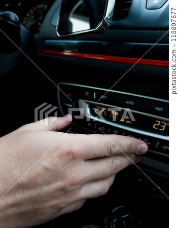 Male hand set the temperature in the car. Male hand set the temperature in the car. 118897877