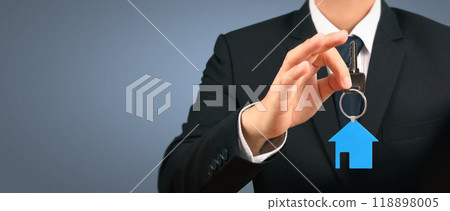 Real estate agent handing over house keys in hand Real estate agent handing over house keys in hand 118898005