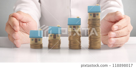 Hands and stock coins and model house ,money saving ,Business idea Hands and stock coins and model house ,money saving ,Business idea 118898017