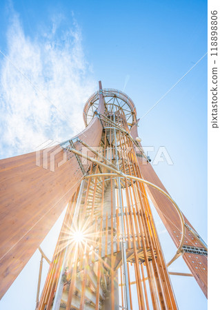 The distinctive Hamstejn lookout tower stands tall in Bohemian Paradise, featuring a spiral staircase and a unique steel tube design. Visitors can admire sweeping views of the landscape. 118898806