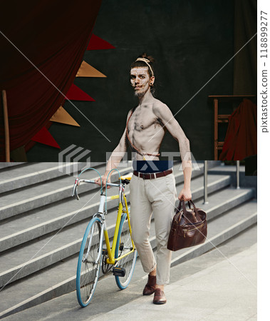 Fire juggler with bag. Creative collage. Top half features a circus performer, while the lower half is a modern businessman with a leather bag and a bicycle Fire juggler with bag. Creative collage. Top half features a circus performer, while the lower half is a modern businessman with a leather bag and a bicycle 118899277
