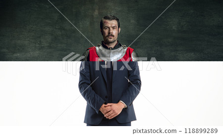 Knight businessman. Creative collage. Medieval knight in armor on top, with a modern man in a suit from the waist down. Knight businessman. Creative collage. Medieval knight in armor on top, with a modern man in a suit from the waist down. 118899289