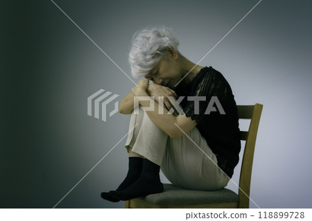 Gray-haired senior woman holding her stomach, stiff shoulders 118899728