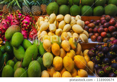 assortment of various tropical fruits on the market in Asia. Exotic fruits on counter in a street store in Vietnam. Mango, pitahaya, pineapple, mangosteen and passion fruit 118900674
