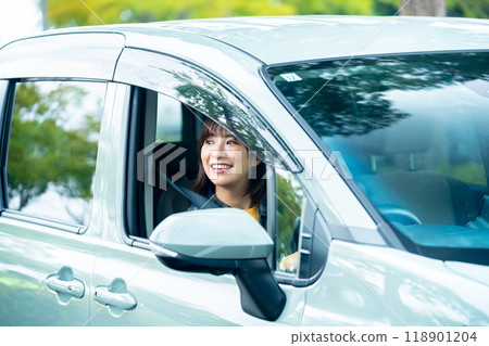 A woman driving a car A woman going for a drive 118901204