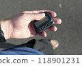 Man pulled out pager with a display from his pocket on the street 118901231