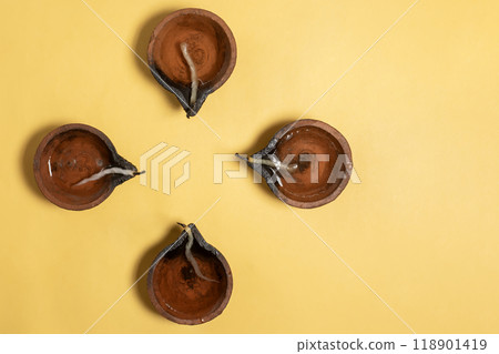 Happy Diwali - Traditional clay diya arrangement for Diwali celebration on yellow background. Happy Diwali - Traditional clay diya arrangement for Diwali celebration on yellow background. 118901419