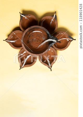 Handmade clay oil lamp on yellow background. It is used during Diwali, Karthigai Deepam and other Indian festivals celebrations. 118901428