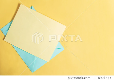 Colorful blue and yellow paper envelope on yellow background with copy space. 118901443