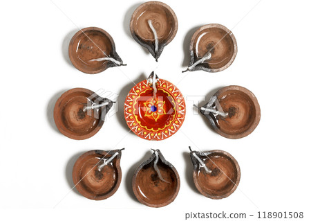 Traditional clay oil lamps are arranged in a circle during Diwali festival. Traditional clay oil lamps are arranged in a circle during Diwali festival. 118901508