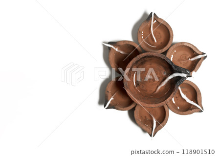 Happy Diwali - Traditional clay diya lamps on white background during Diwali festival celebration. Happy Diwali - Traditional clay diya lamps on white background during Diwali festival celebration. 118901510