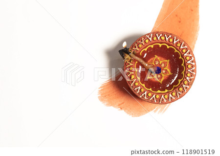 Hindu tradition Diwali diya oil lamps burning over paint stroke on white background. 118901519
