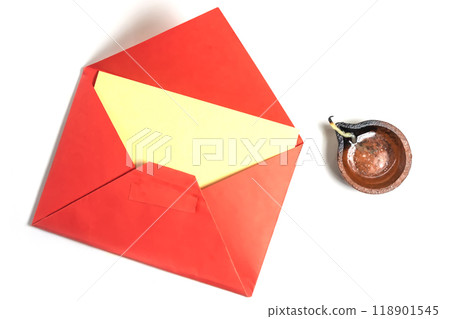 Red envelope with blank yellow paper greeting card with handmade clay diya isolated on white background for Diwali festival. 118901545