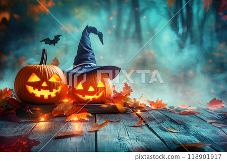 Halloween jack-o'-lanterns and witch hats decorate an autumn forest 118901917