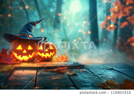 Halloween jack-o'-lanterns and witch hats decorate an autumn forest 118901918