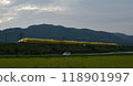 A yellow Shinkansen train racing through the Showa era countryside 118901997