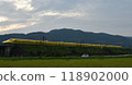 A yellow Shinkansen train racing through the Showa era countryside 118902000