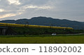 A yellow Shinkansen train racing through the Showa era countryside 118902002