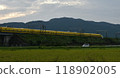 A yellow Shinkansen train racing through the Showa era countryside 118902005