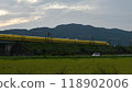 A yellow Shinkansen train racing through the Showa era countryside 118902006