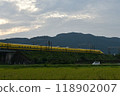 A yellow Shinkansen train racing through the Showa era countryside 118902007