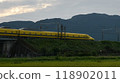 A yellow Shinkansen train racing through the Showa era countryside 118902011
