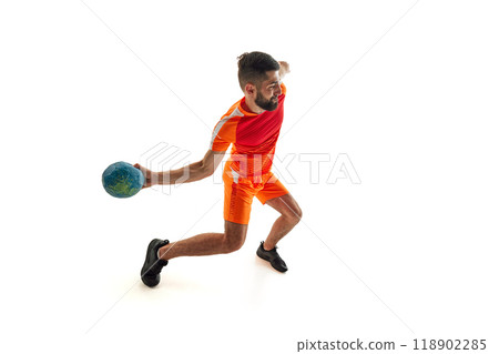 Scoring winning goals. Competitive young man, handball player in motion during intense game, playing isolated on white background Scoring winning goals. Competitive young man, handball player in motion during intense game, playing isolated on white background 118902285