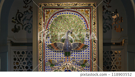 Replica Of Peacock Mosaic Wall From Mor Chowk Or Peacock Square Of Udaipur City Palace. Peacocks Have Been Crafted With 5000 Pieces Of Glass, Which Shine In Green, Gold, And Blue Colours Replica Of Peacock Mosaic Wall From Mor Chowk Or Peacock Square Of Udaipur City Palace. Peacocks Have Been Crafted With 5000 Pieces Of Glass, Which Shine In Green, Gold, And Blue Colours 118903552