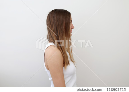 Profile view of young woman demonstrating her problematic long damaged hair, unhealthy, messy, isolated on background. Girl problem hair-type. Spit ends dry over-brushing hairstyle. Haircare concept 118903715
