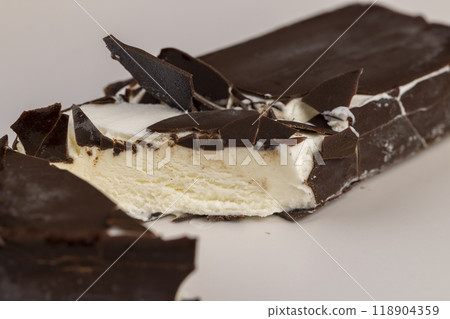 natural eco-friendly ice cream in chocolate glaze lies on a plate natural eco-friendly ice cream in chocolate glaze lies on a plate 118904359