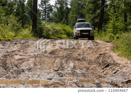 Japanese SUV on a muddy road at the Khuvsgul lake in Mongolia. Japanese SUV on a muddy road at the Khuvsgul lake in Mongolia. 118904667