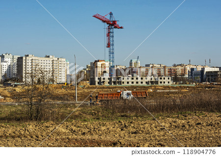 Belarus, Minsk - 20.04.2017: Tower crane on the construction of a multistory apartment building Belarus, Minsk - 20.04.2017: Tower crane on the construction of a multistory apartment building 118904776