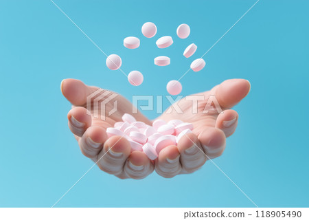 Hands catching falling pink pills against a blue background 118905490