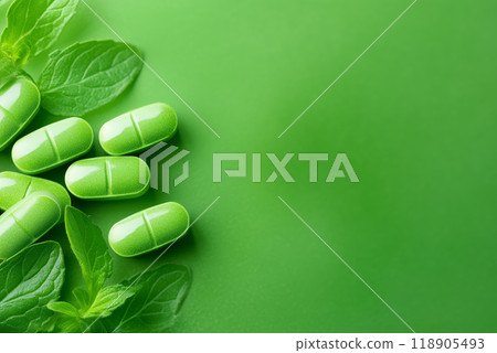 Green capsules with mint leaves on a colorful background 118905493