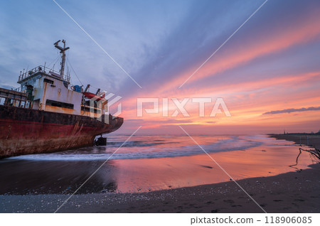 Silhouetted Shipwreck at Sunset, Xigushui Beach, Tainan. 118906085