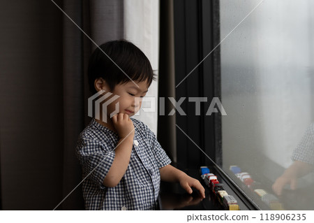 Toddler looking out the window 118906235