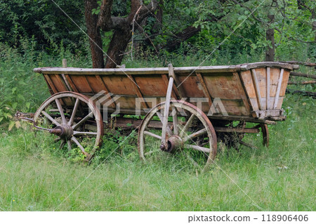 Traditional country cart in nature background. Vintage wooden transport. Traditional country cart in nature background. Vintage wooden transport. 118906406