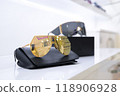 Gold and black lens fashion sunglasses displayed on black cases, showcasing modern minimalism, luxury eyewear, premium accessories, reflecting elegant design, retail presentation, stylish chic look. 118906928