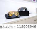 Stylish gold and black lens sunglasses on sleek black cases, reflecting modern minimalism, luxury fashion accessories, premium eyewear presentation, showcasing elegant design, fashion-forward style. 118906946