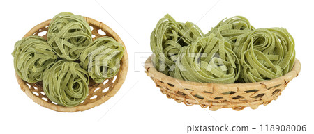 Raw tagliatelle green pasta with spinach in a wicker basket isolated on white background. Top view. Flat lay. Raw tagliatelle green pasta with spinach in a wicker basket isolated on white background. Top view. Flat lay. 118908006