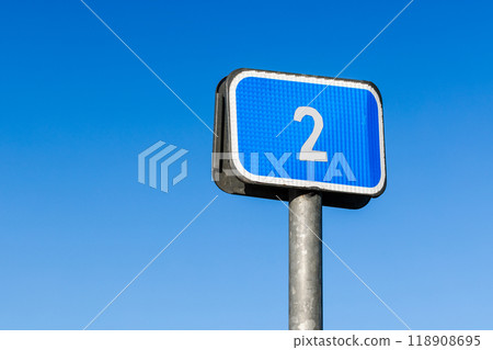 Blue road sign with 2 sign is under blue sky background, close up Blue road sign with 2 sign is under blue sky background, close up 118908695