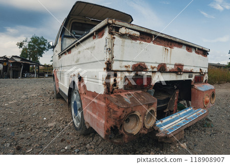 Rusty vintage truck parked in an abandoned area under a cloudy sky Rusty vintage truck parked in an abandoned area under a cloudy sky 118908907