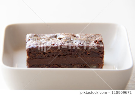 Chocolate brownie on a white plate Chocolate brownie on a white plate 118909671