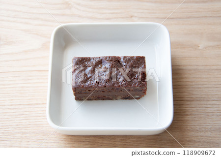 Chocolate brownie on a white plate Chocolate brownie on a white plate 118909672